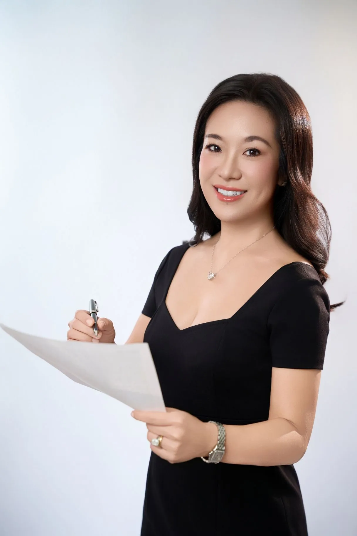 Dr. Nao J. Gamo holding a pen and paper